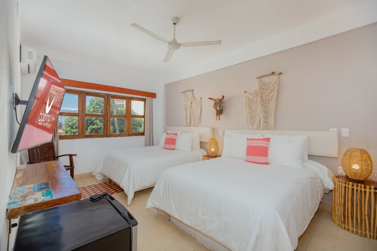 Room 204 with two Queen beds, TV, and a window with a view