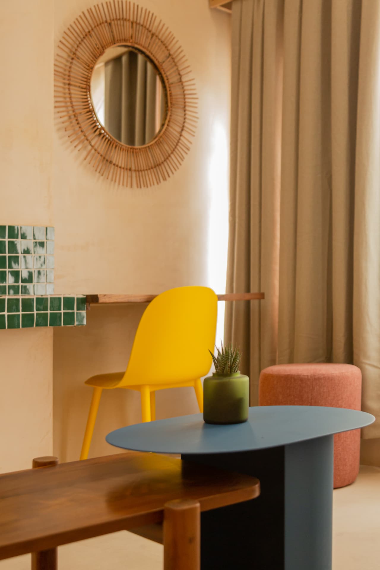 Common area of Amaca Residence with desk, yellow chair, blue table and natural fiber details