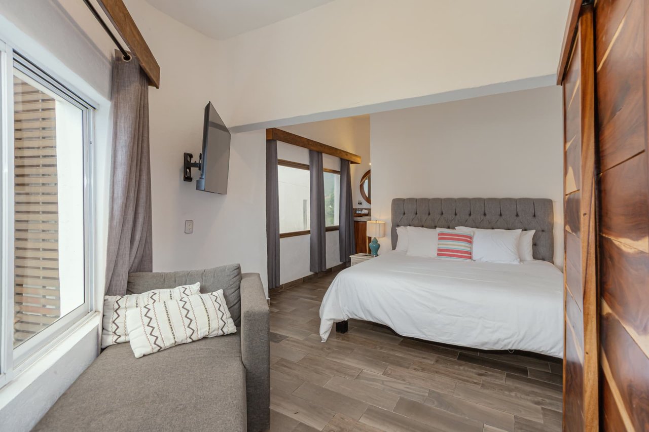 First King bedroom of the Penthouse with seating area