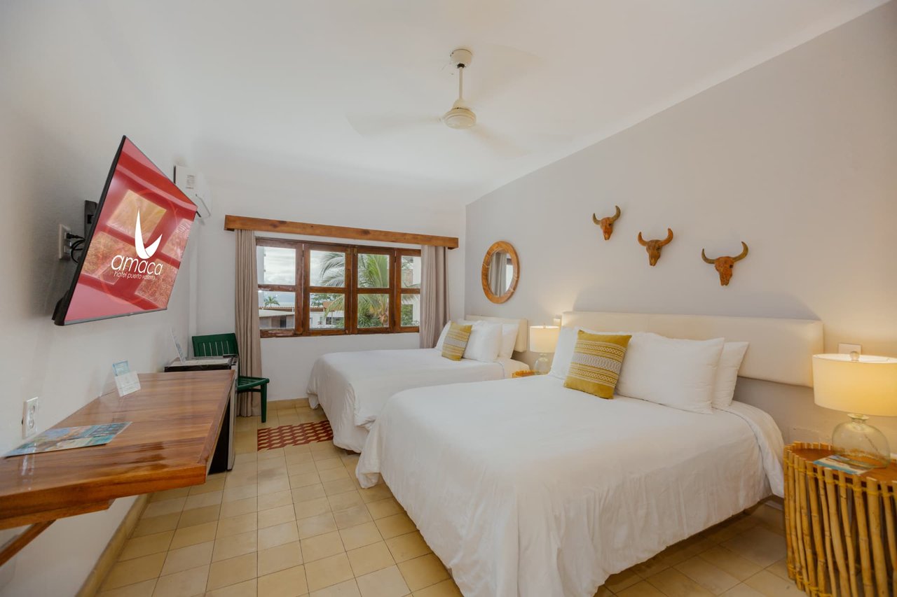 Room 304 with two Queen beds, wooden desk, and a window with a view