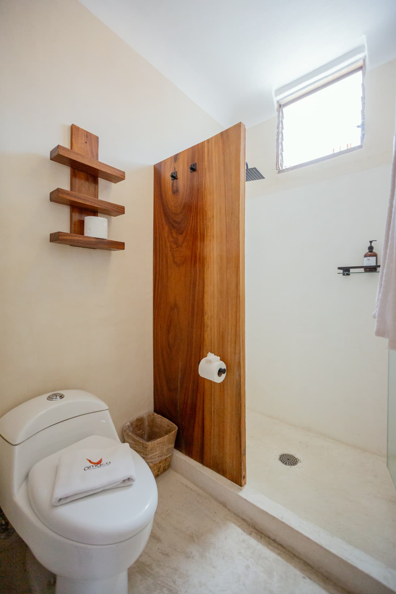 Shower in Room 202's bathroom with glass enclosure and skylight window
