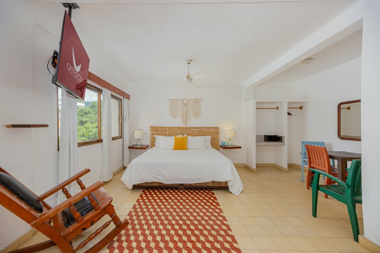 Room 207 with a Queen bed, wardrobe, and work desk