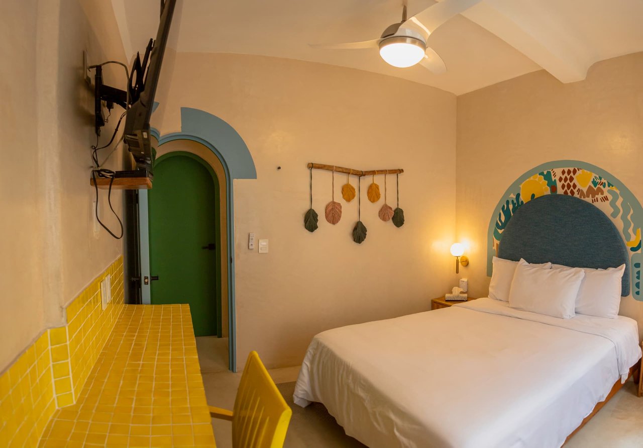 Second Queen bedroom of Amaca Residence with yellow mosaics and green door