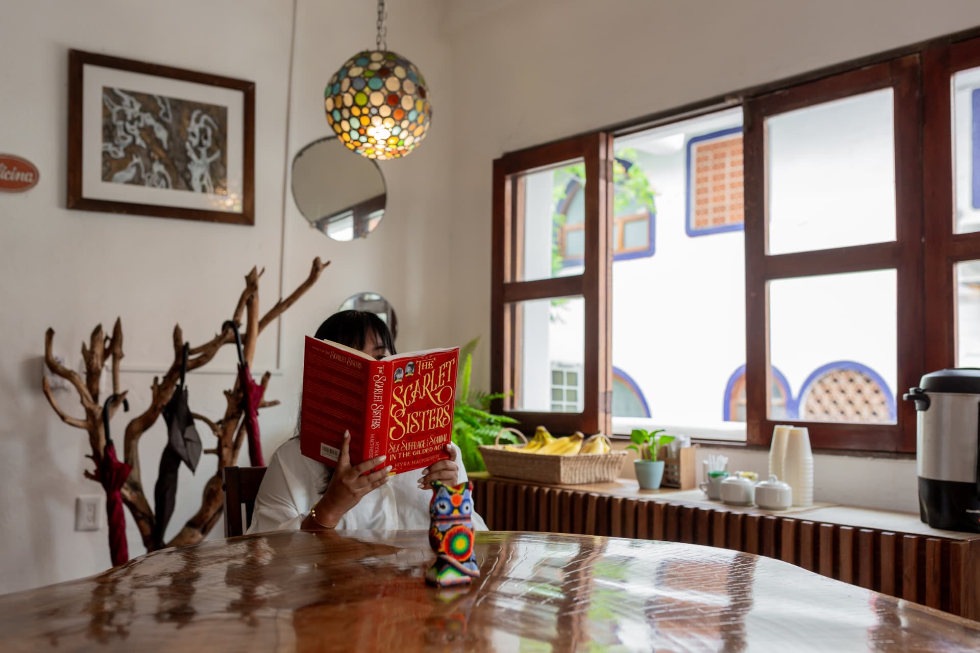 Breakfast dining room with wooden windows, coffee, and morning reading