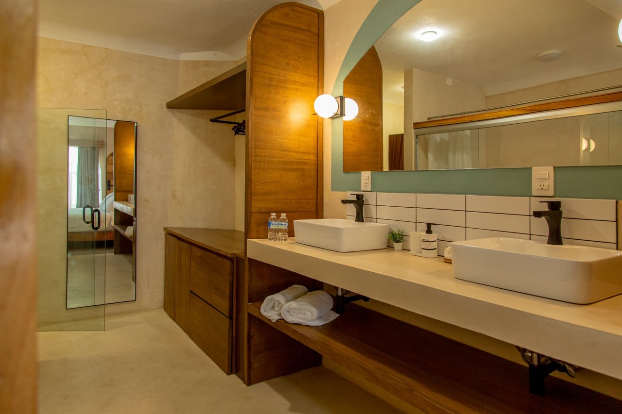 Double bathroom of Amaca Residence with mirrors, sinks and wood finishes