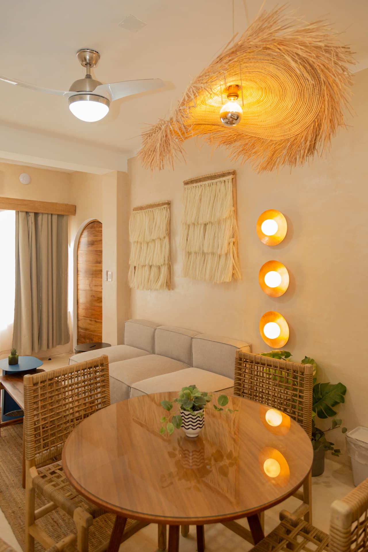 Dining area and living room of Amaca Residence with natural fiber lamp and warm lighting