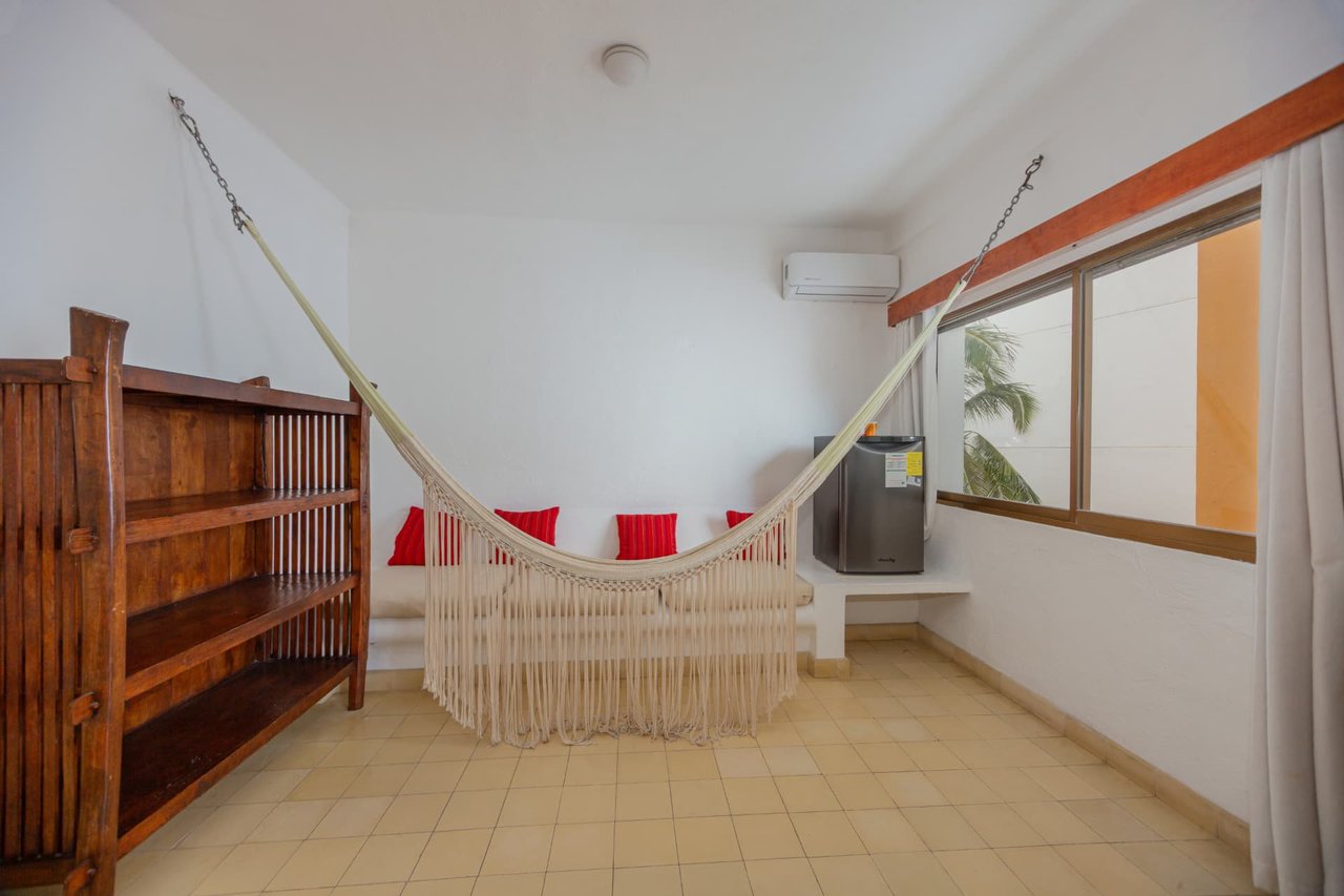 Hammock with red cushions and minibar in room 207