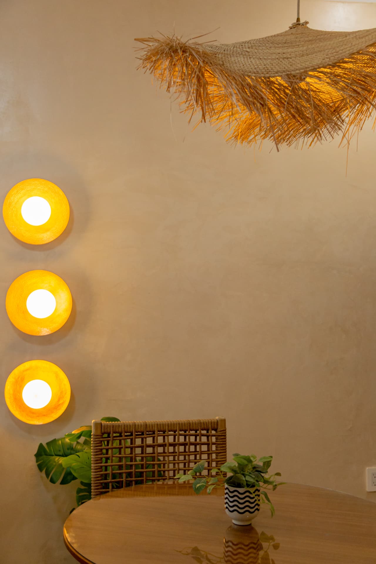 Dining area of Amaca Residence with natural fiber lamp and handcrafted lighting