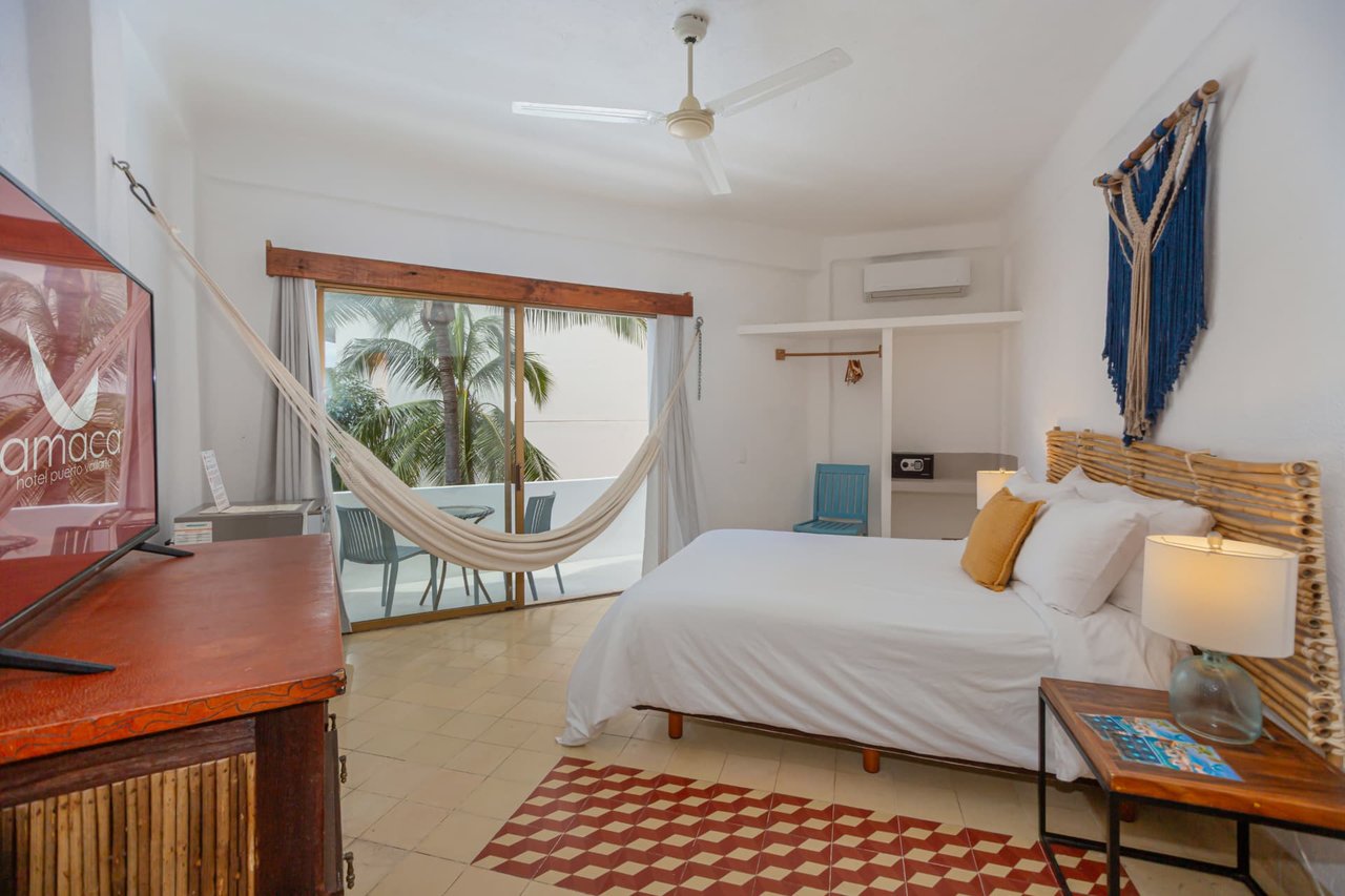Room 206 with Queen bed, bamboo dresser and balcony access
