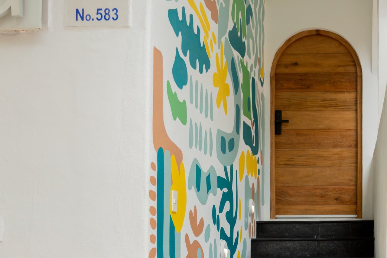 Detail of the mural and independent entrance door of Amaca Residence